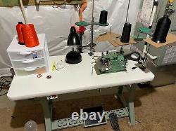 Merrow MG-3U-V Overlock Machine (2020 model) with table, motor, parts, and threads